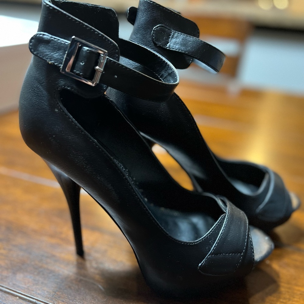 Black platform stilettos by Venus. Size 7 1/2 worn once. Sexy and comfortable.